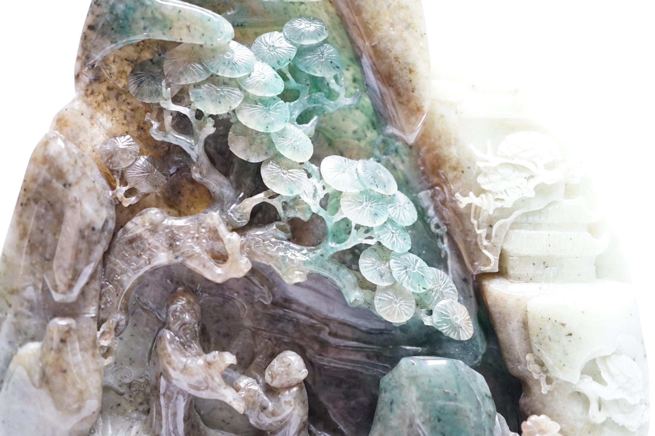 A Chinese jadeite boulder carving on hardwood stand, 17cm high